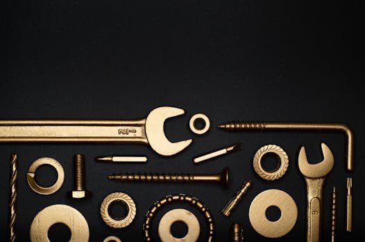Artistic arrangement of gold tools on a black background, offering ample copy space.